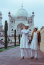 Man in White Thobe Standing Beside Woman in White Robe