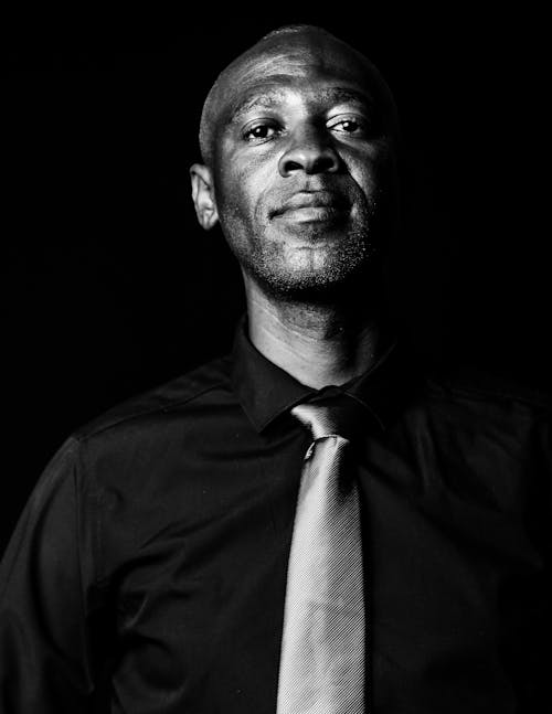 Grayscale Photo of a Man Wearing a Necktie