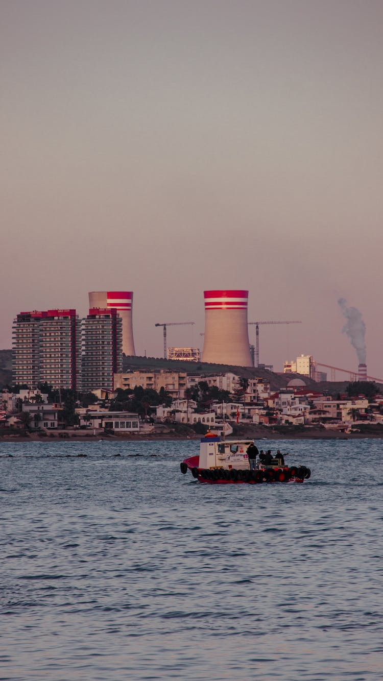 Chimneys And Boat On River