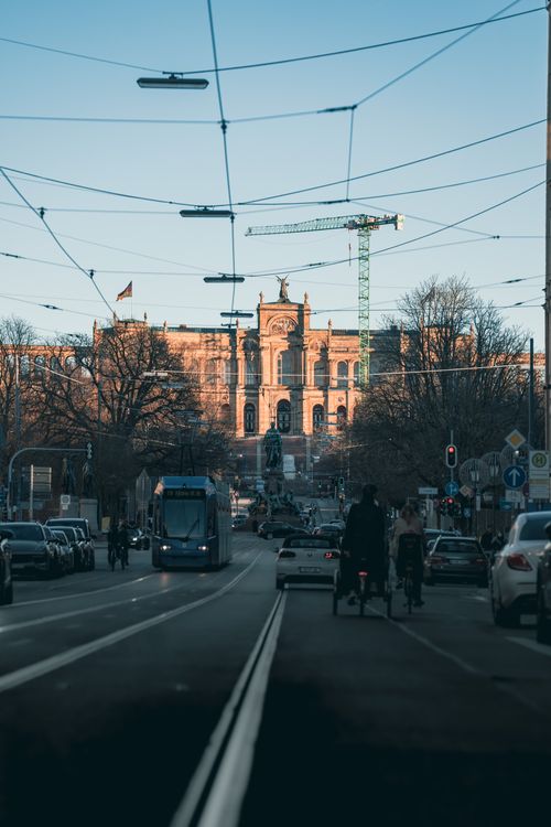 Free City street scene with the Maximilianeum in Munich, captured on a clear day with urban traffic. Stock Photo