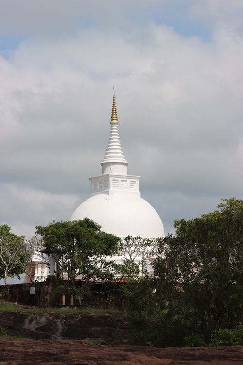 Free Captivating view of the iconic stupa at Thanthirimale amidst lush greenery and a clear sky. Stock Photo