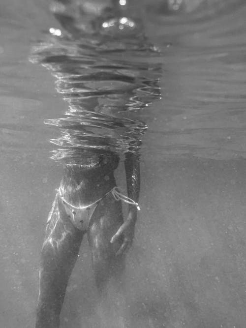 Woman Swimming under Water