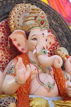 Close-up of a colorful, ornate Ganesha statue symbolizing Hinduism and Indian culture.