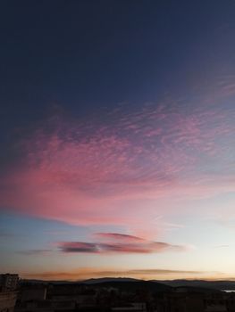 Mesmerizing pink clouds against a deep blue sky at sunset, perfect for calming wallpapers.