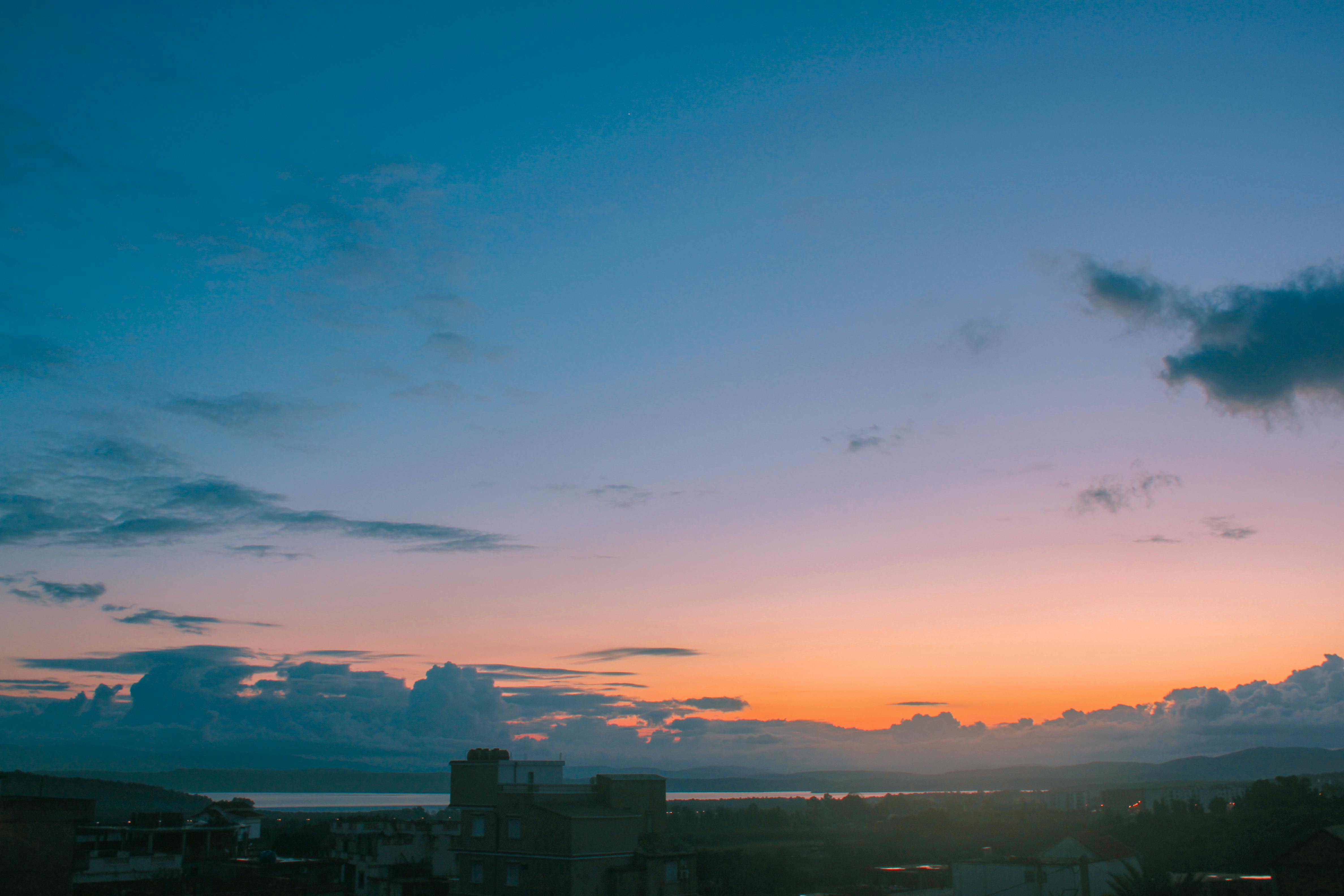 Beautiful cityscape during sunset with a colorful sky and distant horizon.