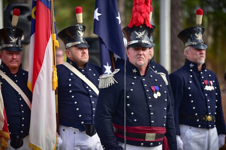 Men Wearing Military Uniforms On Parade