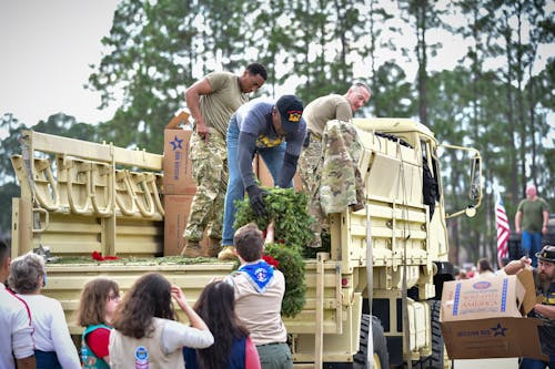 People on Truck Cooperate with Scouts