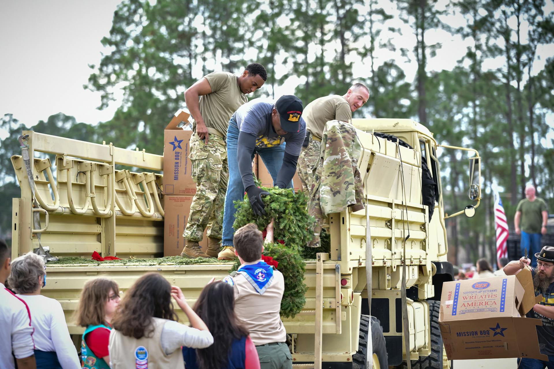 People on Truck Cooperate with Scouts
