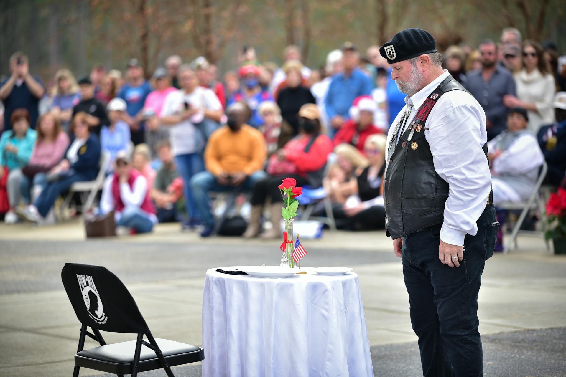 Veteran Standing by Table Covered with White Clothes