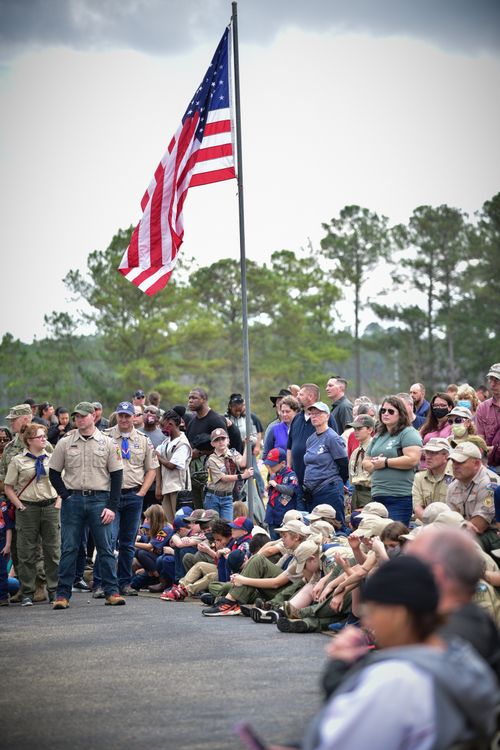 Free A community event featuring scouts gathered under the American flag outdoors. Stock Photo