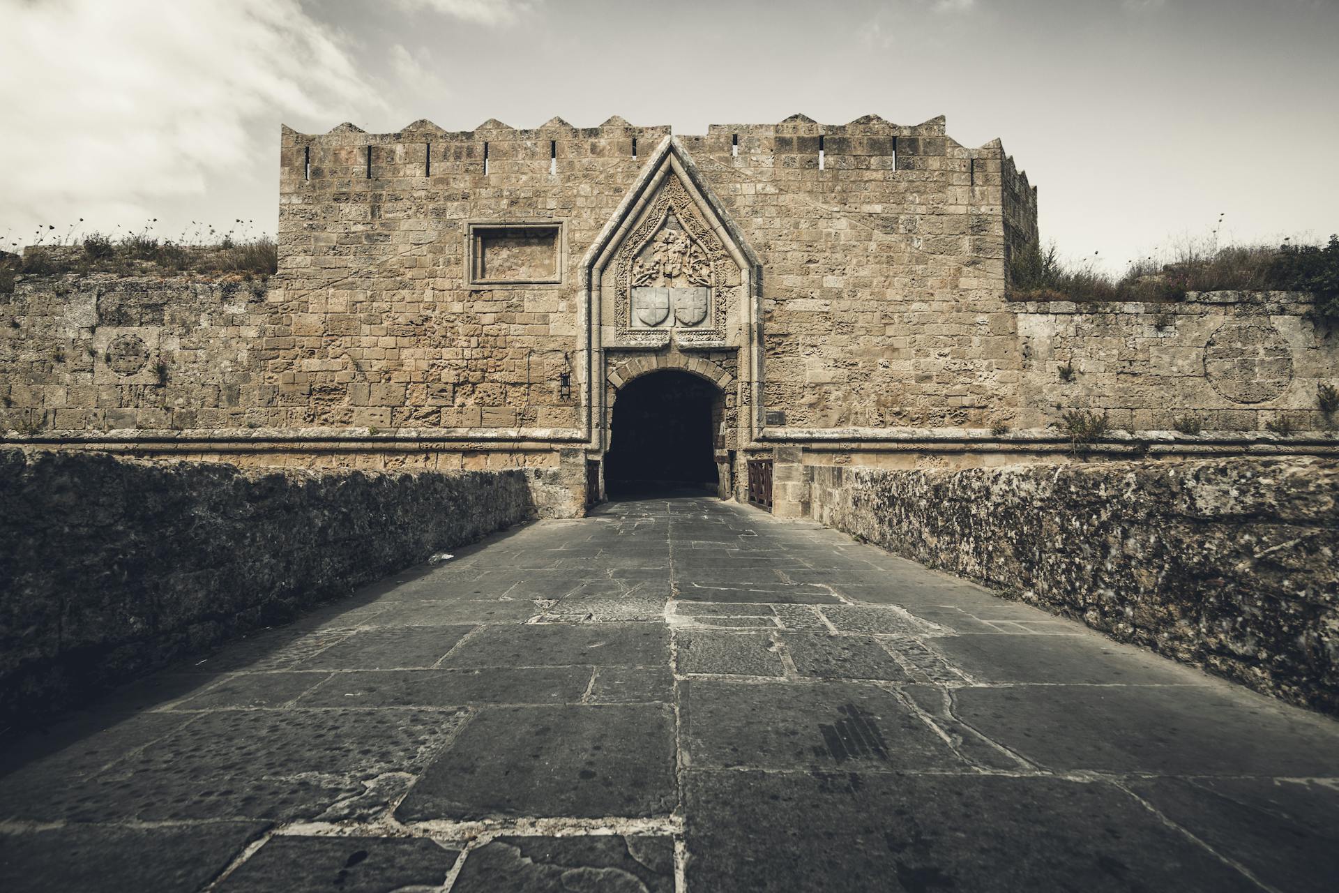 Explore the ancient stone gate of Rhodes castle, a landmark of medieval architecture.