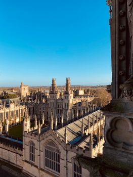 Elevated view of All Souls College in Oxford showcasing Gothic architecture under a clear blue sky.