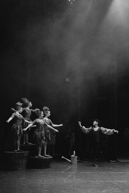 Grayscale Photo of People Dancing on Stage