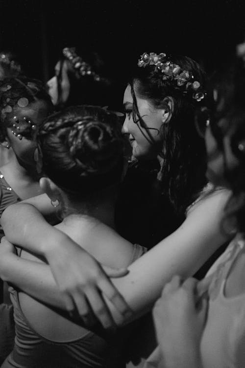 Women Hugging During a Concert