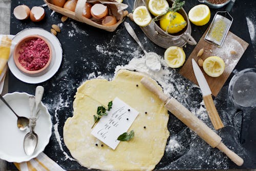 Dough and Flour Near Lemons and Rolling Pin