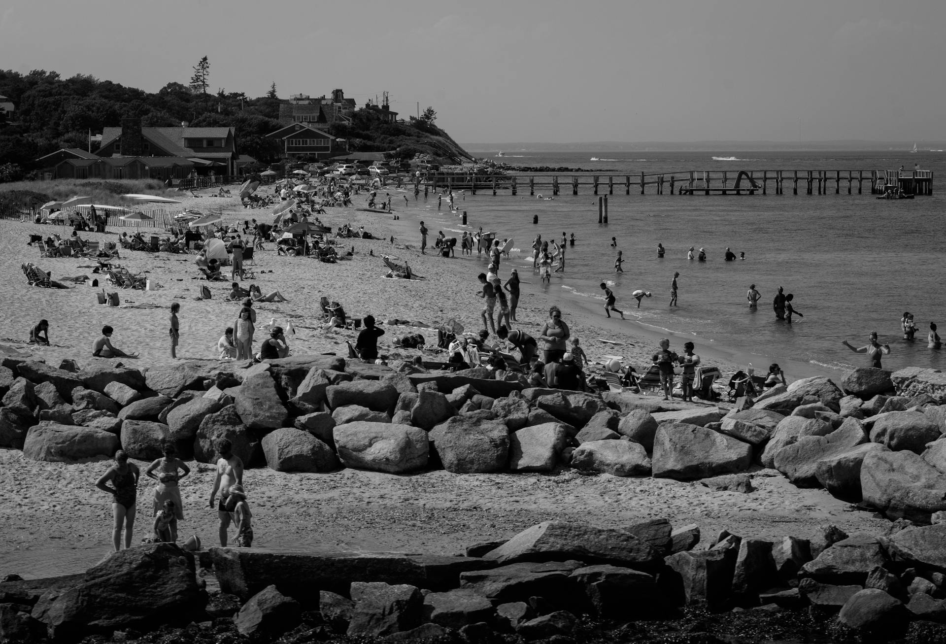 Enjoy a lively black and white scene at Martha's Vineyard beach, capturing summer crowds and shoreline activities.