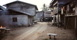 White and Blue Table and Chairs Near Brown Wooden House