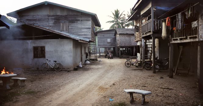 White and Blue Table and Chairs Near Brown Wooden House