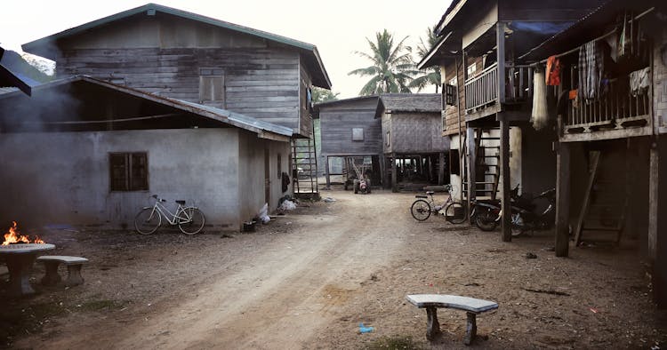 White And Blue Table And Chairs Near Brown Wooden House