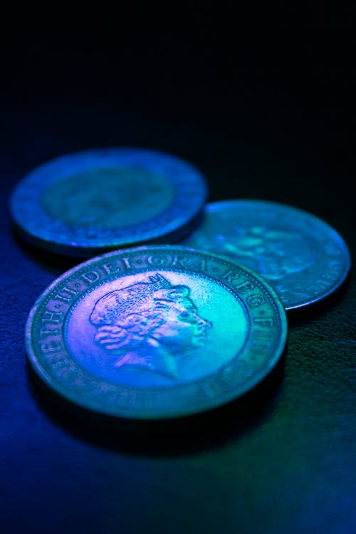 Free Silver Coins on Black Surface Stock Photo