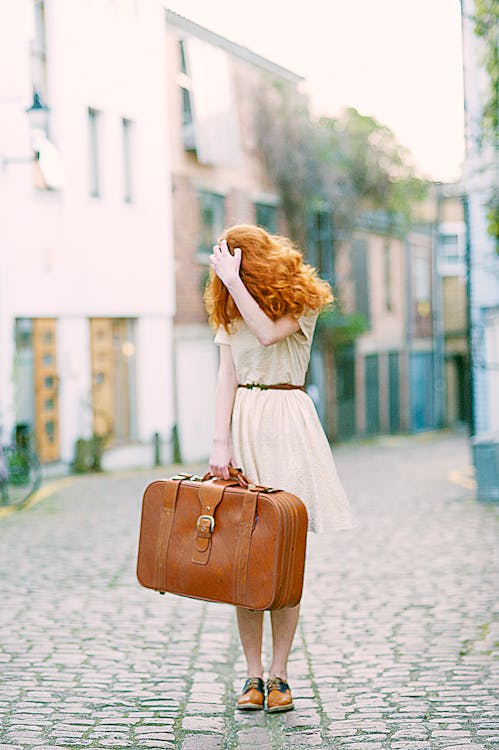 Woman In White Short-sleeved Dress Holding Brown Leather Suitcase