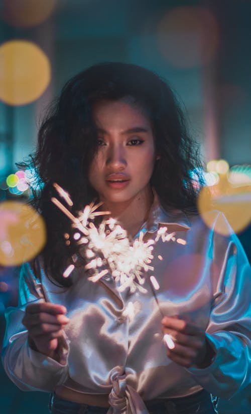 A Woman Holding Burning Sparklers
