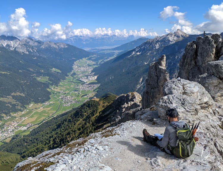 Person Sitting On Mountain Top