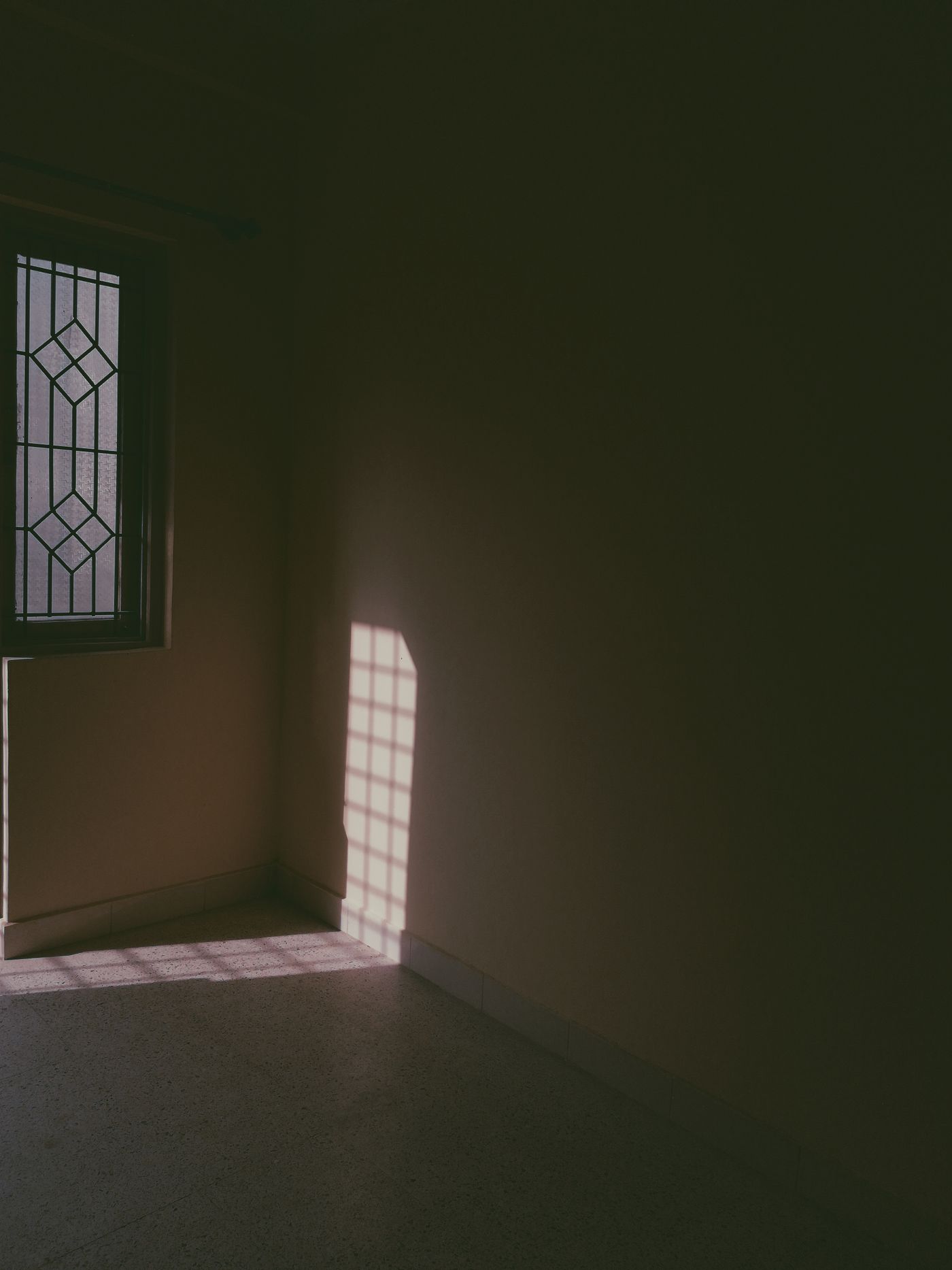 An empty room with light through a window