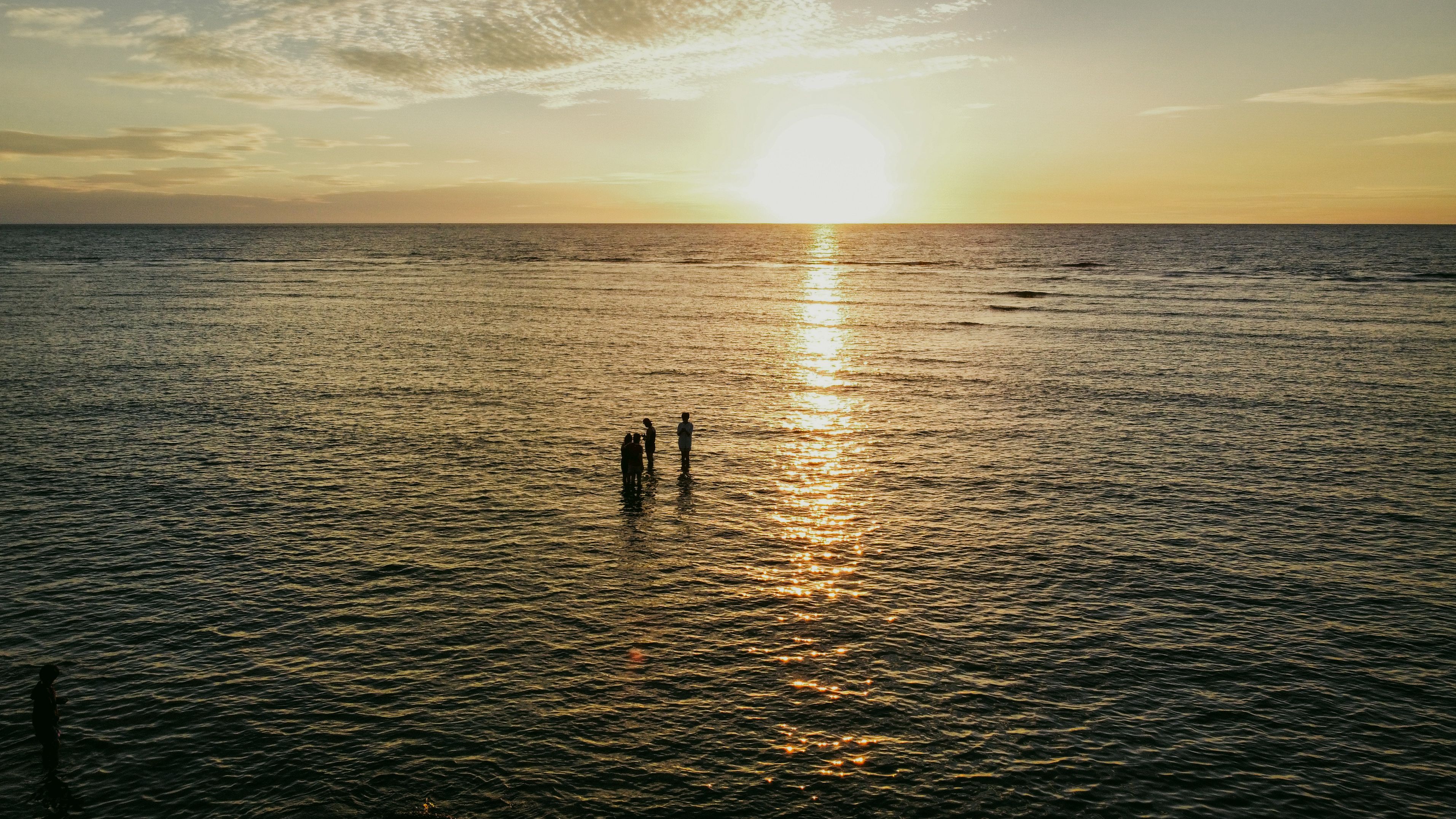 Silhouette of People Standing on Sea Water during Sunset · Free Stock Photo