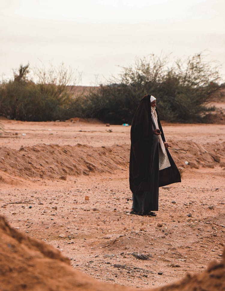 Woman In Black Dress On Wasteland