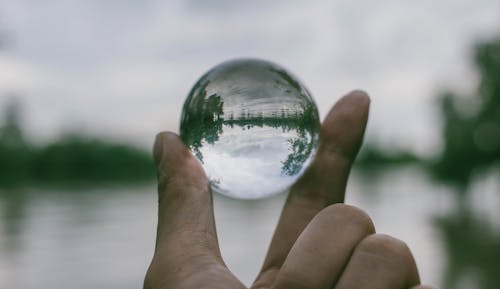 Free Close-Up Photography of Person Holding Crystal Ball Stock Photo