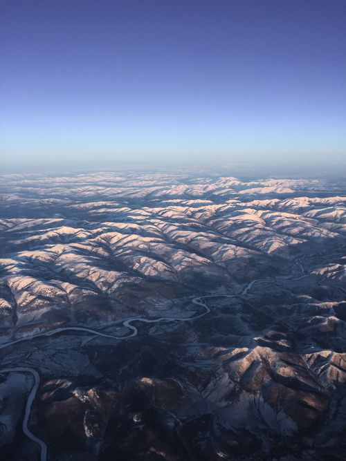 Free A breathtaking aerial view of snow-covered mountains in Russia at dawn, showcasing natural beauty in winter. Stock Photo