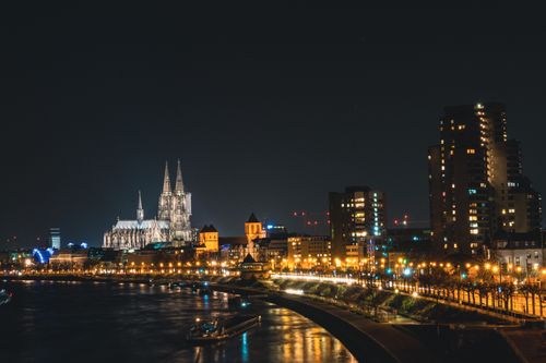 Free Dramatic night view of Cologne Cathedral and city skyline reflecting on the Rhine River, Germany. Stock Photo