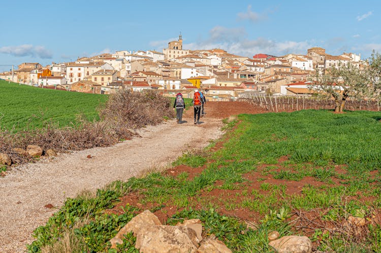 Group With Backpacks Walking On The Way Of St James Towards Galicia, Spain