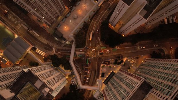 Aerial shot capturing the vibrant streets and towering buildings of Kowloon, Hong Kong.