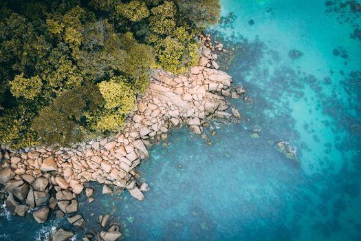 Stunning aerial shot of rocky coastline and turquoise water in Terengganu, Malaysia.