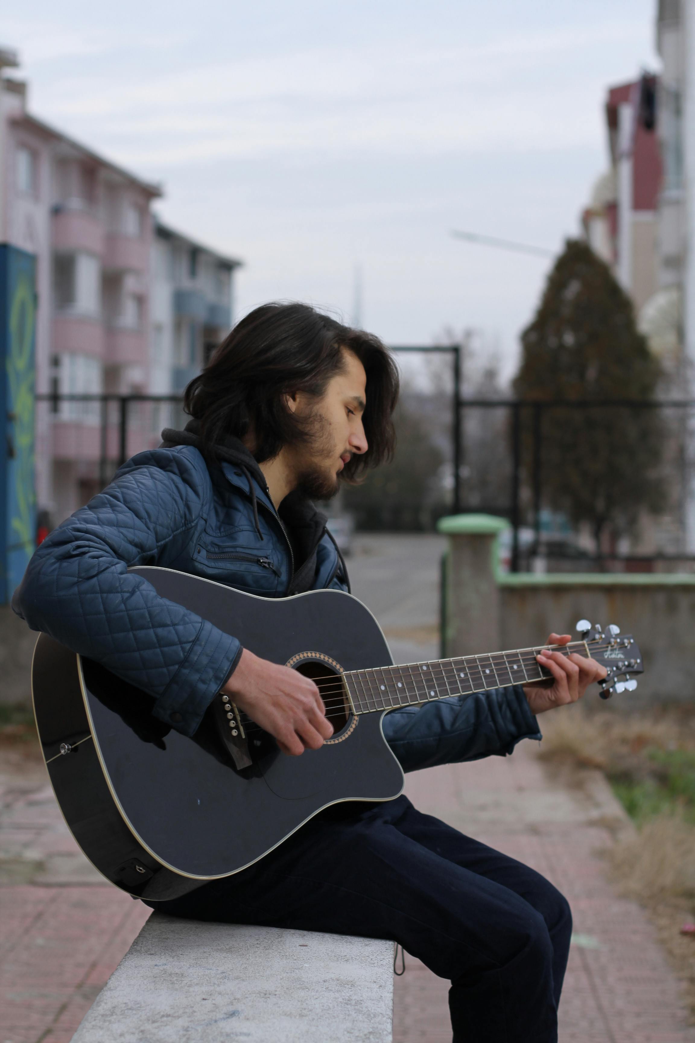 Photo Of Man Sitting While Playing Acoustic Guitar Free Stock Photo   Pexels Photo 1071506 