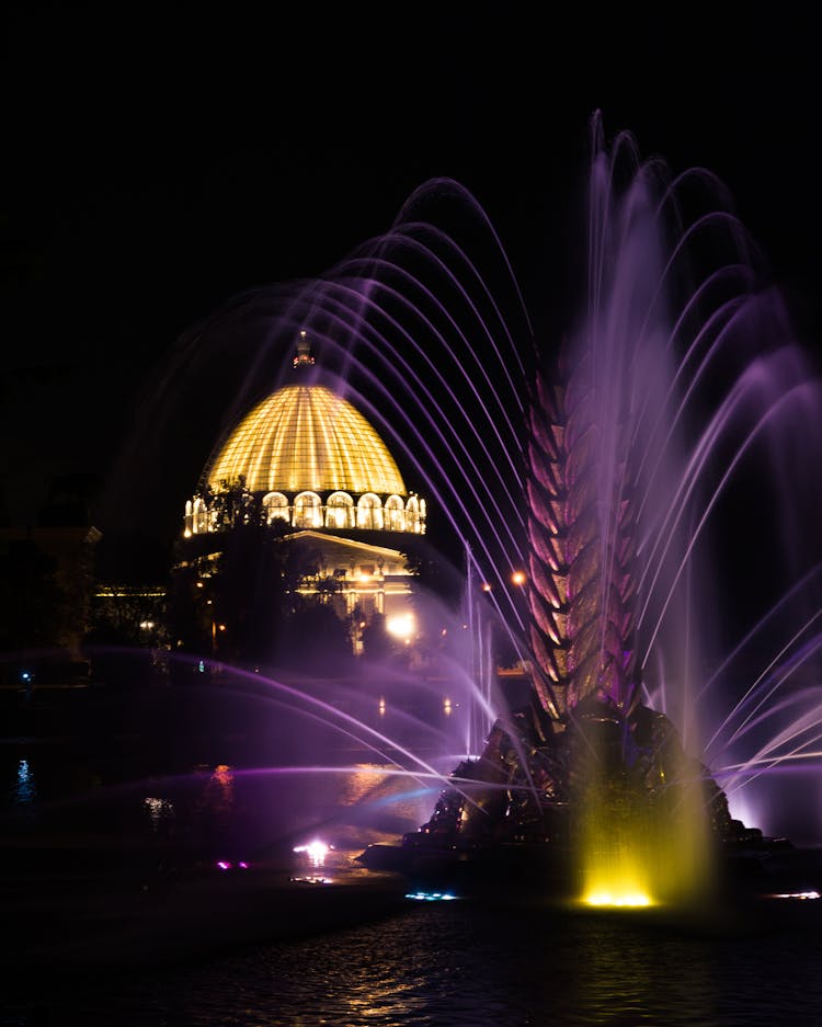 Illuminated Fountain In Night City