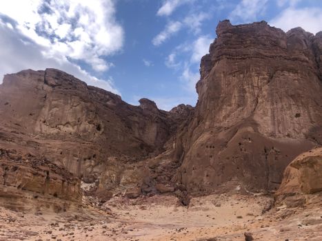 Explore the stunning rock formations and blue sky in this serene desert landscape.