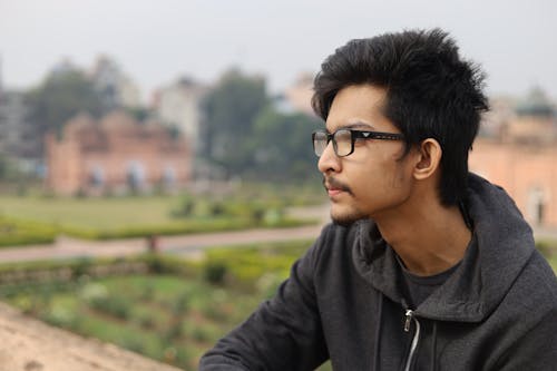 Side View of a Man Wearing Eyeglasses and a Hoodie