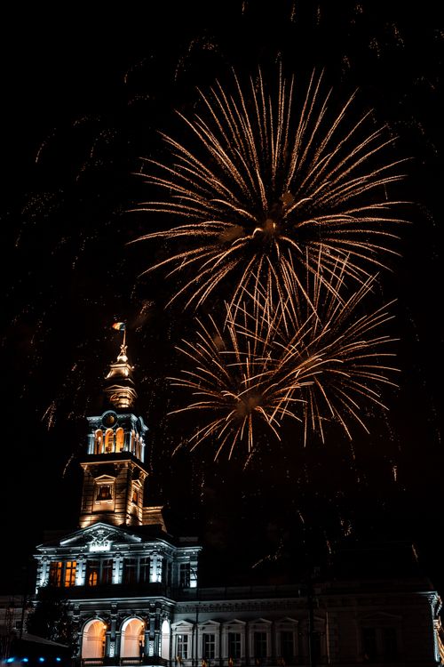 Free Stunning fireworks illuminate Arad City Hall at night, celebrating a festive occasion. Stock Photo