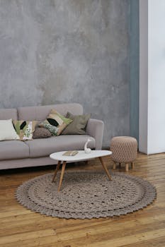 A modern living room featuring a stylish sofa and coffee table with minimalistic decor.