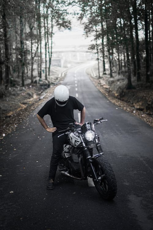 Free Man on Motorcycle in the Middle of Road  Stock Photo