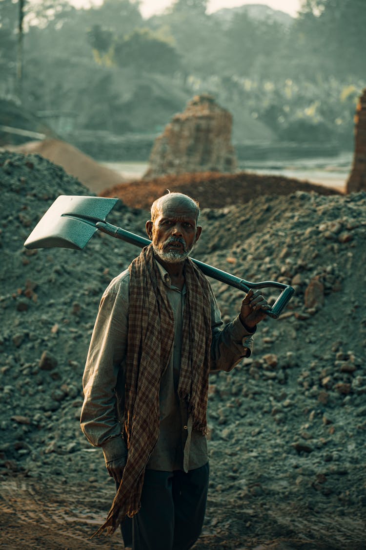 A Man Holding A Shovel