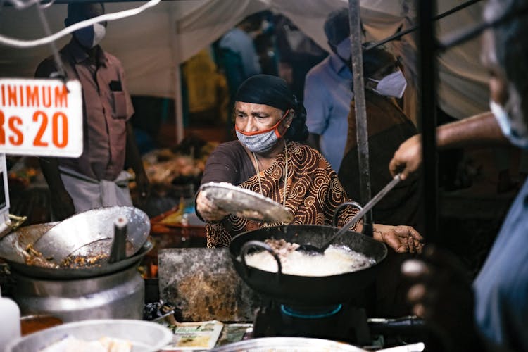 Woman With Mask Cooking Street Food