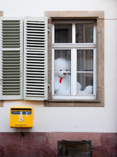 Free White Bear Plush Toy on Yellow Plastic Container Stock Photo