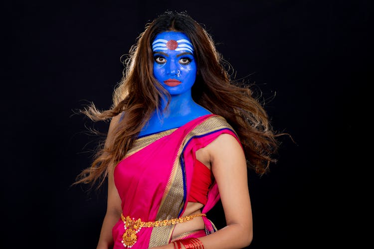 Woman In Blue And Red Face Paint Wearing Blue Face Mask