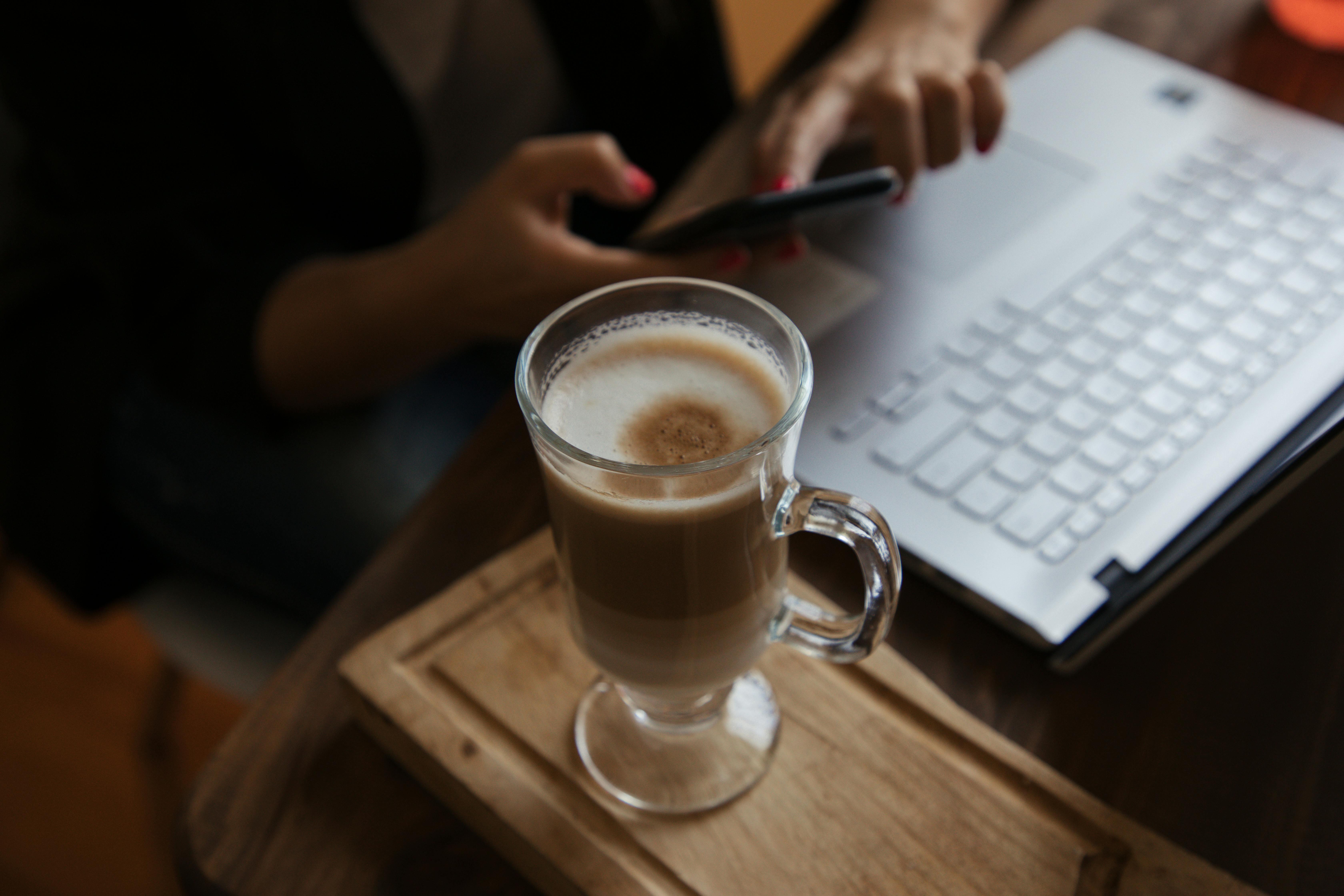 Macbook Beside White Notebook And Pen · Free Stock Photo