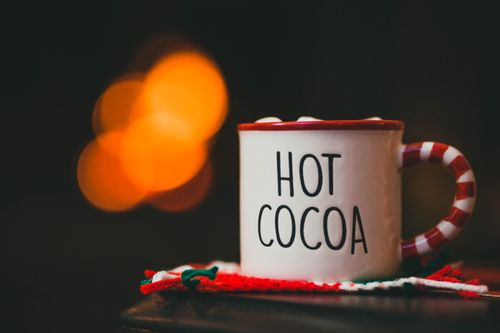 Free Warm and cozy hot cocoa mug with festive bokeh background, perfect for Christmas. Stock Photo