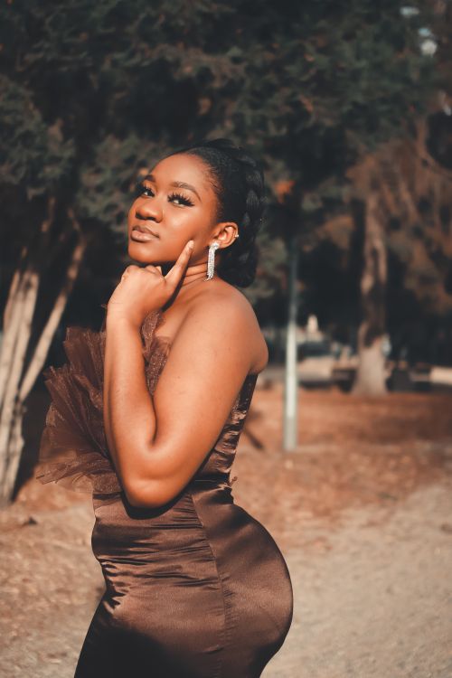 A Woman in Brown Dress Looking with Her Hand on Her Cheek Free Stock Photo A Woman in Brown Dress Looking with Her Hand on Her Cheek Free Stock Photo